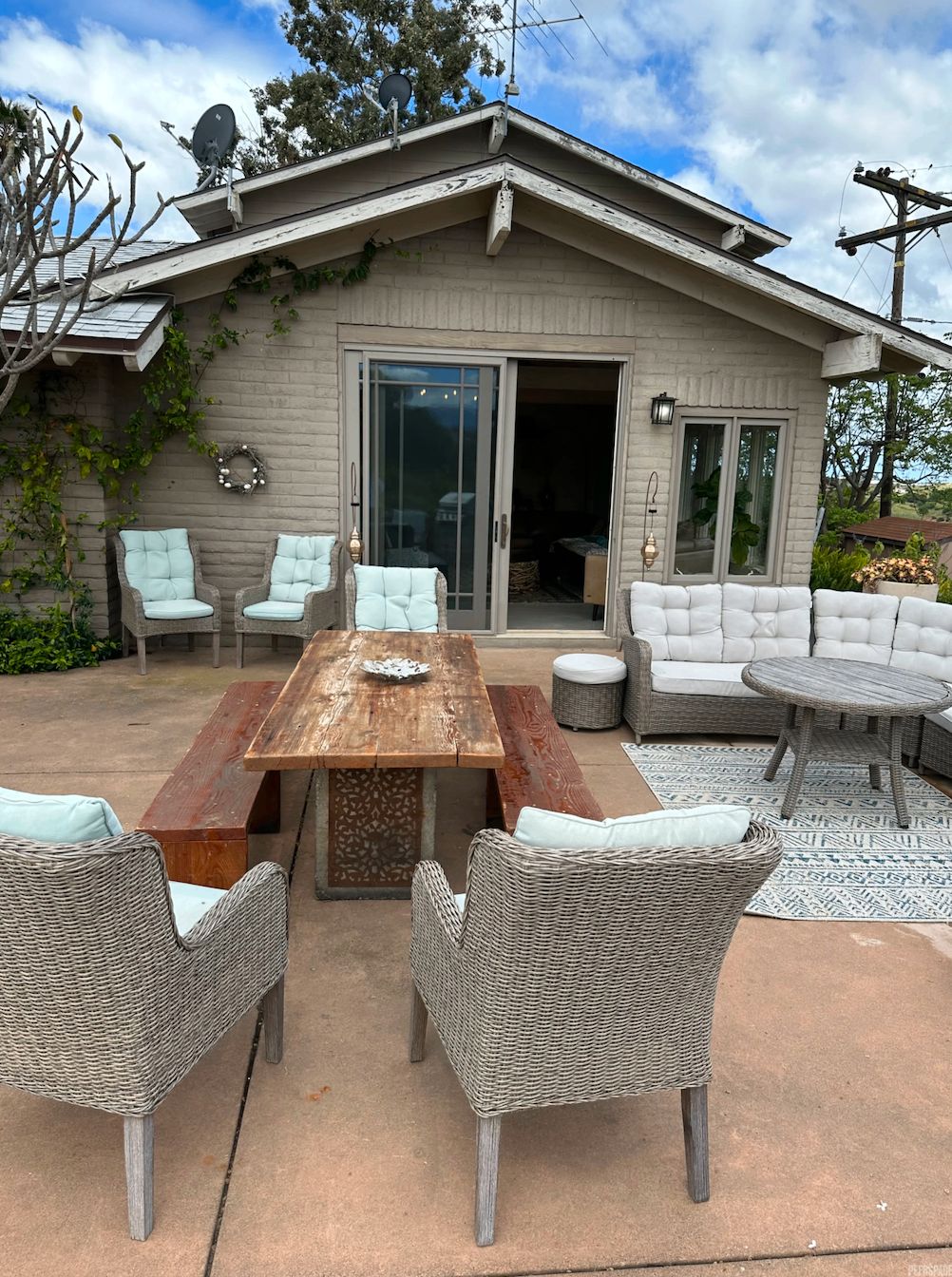 Patio seating outside the estate with rustic dining table