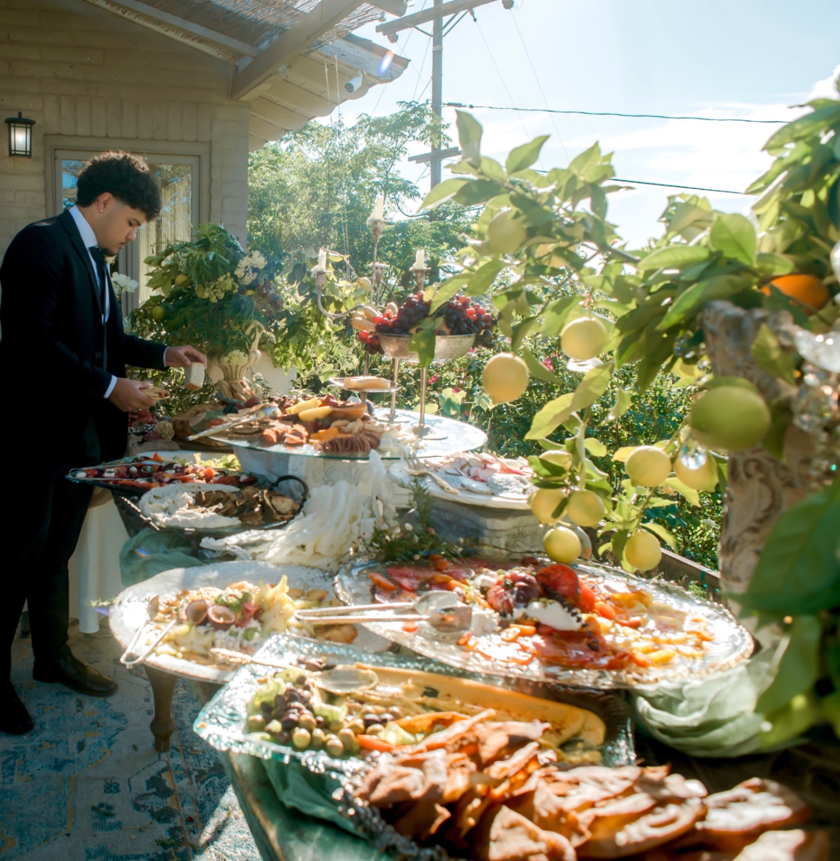 Server styling the orchard buffet table