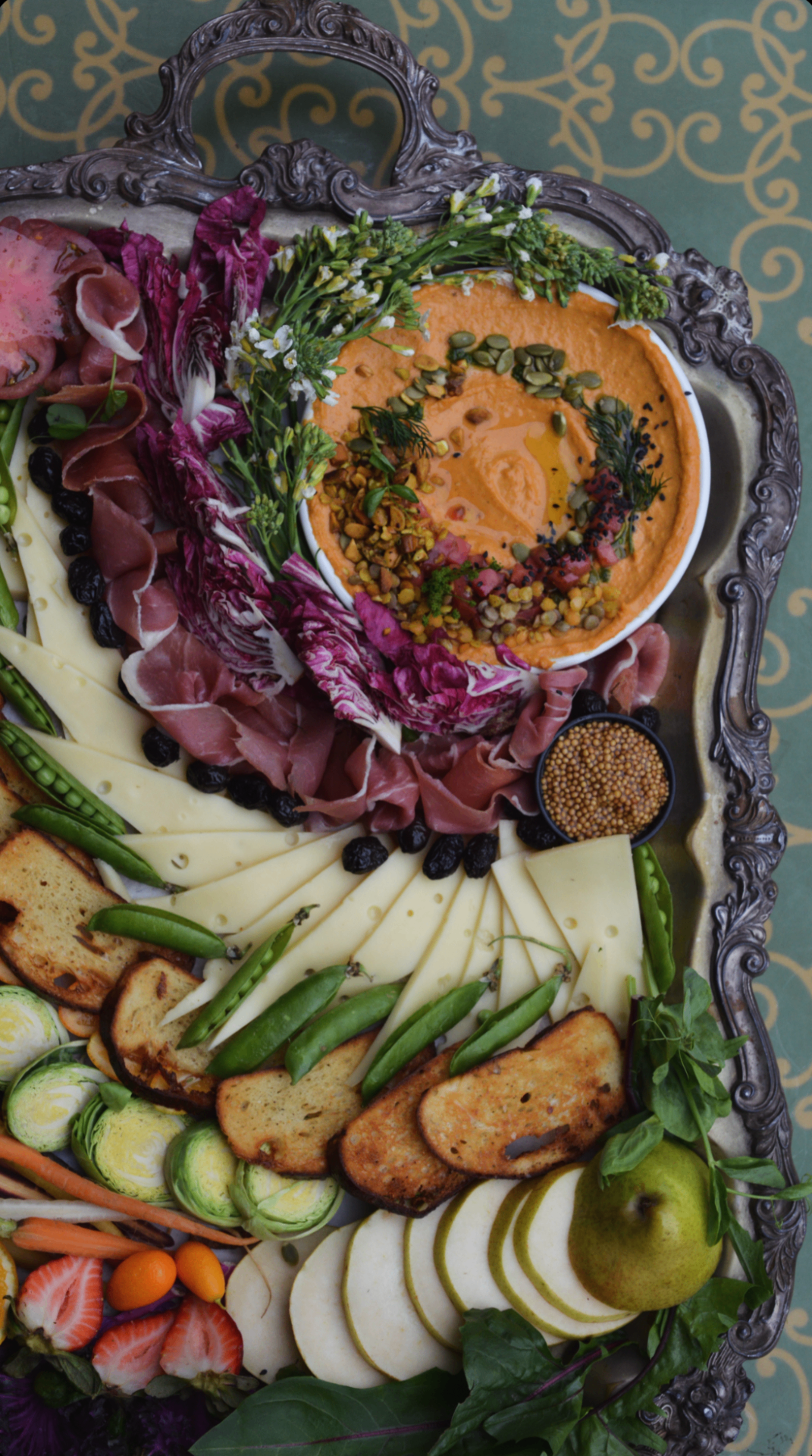 Charcuterie and crudité on an antique silver tray
