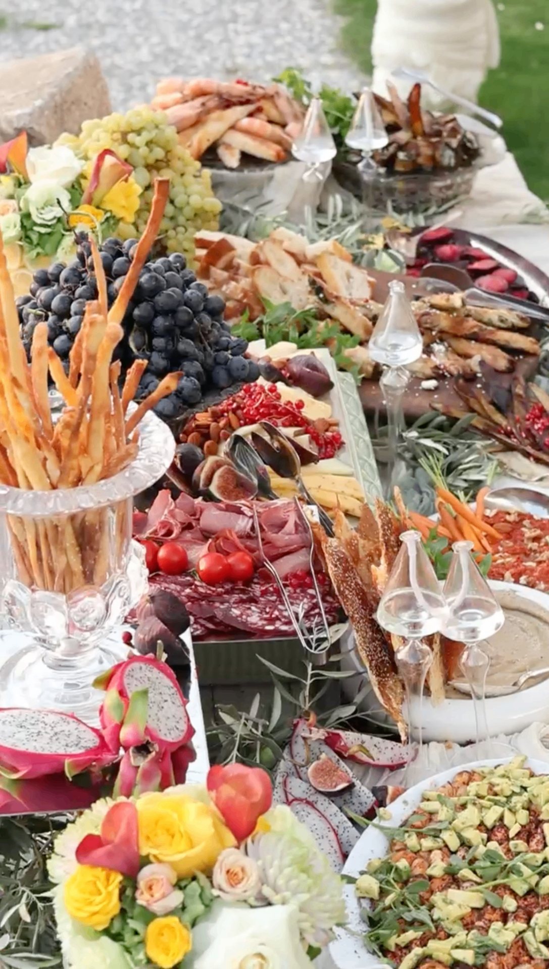 Garden grazing spread with grapes, breads, and florals