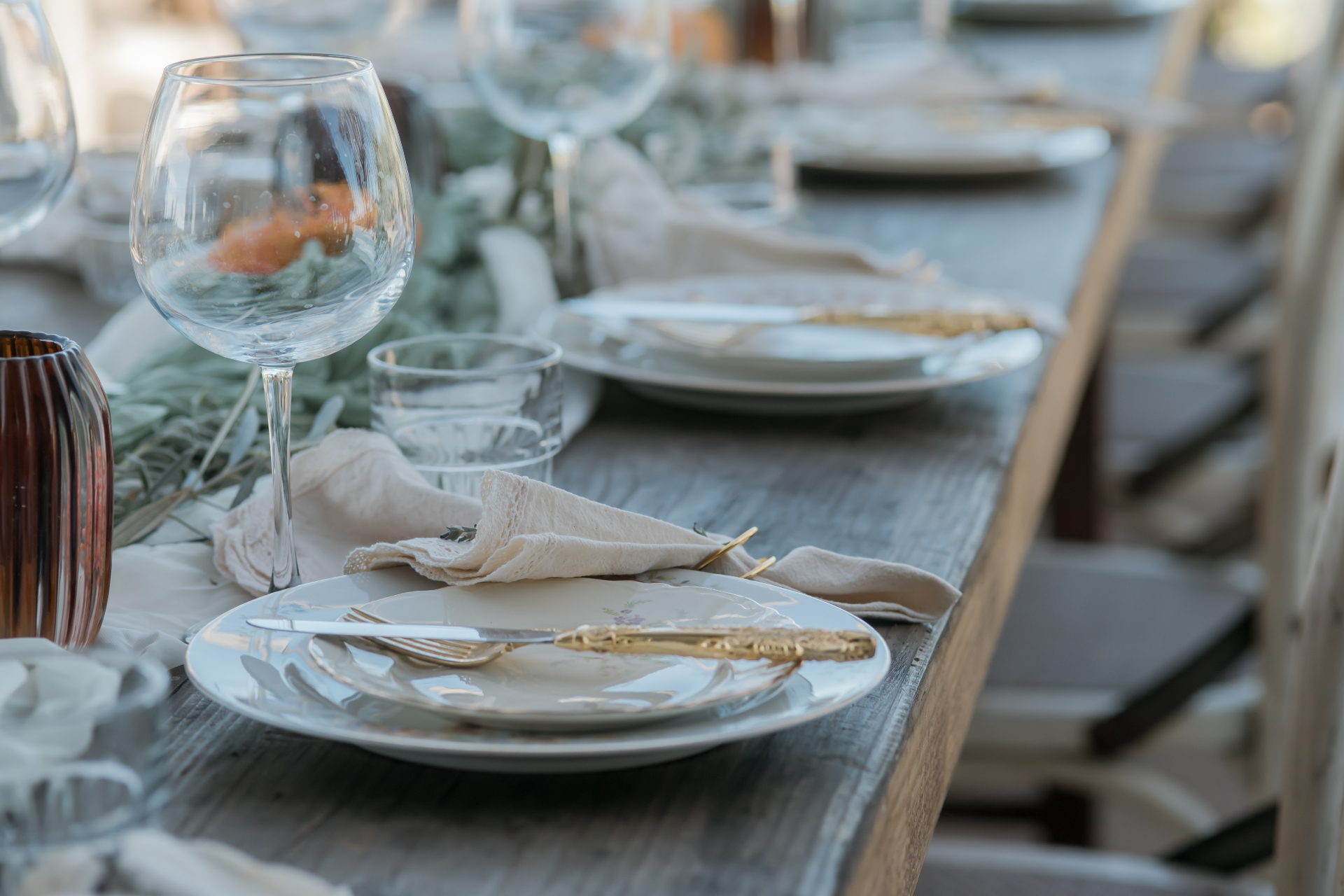Tablescape with vintage china, gold flatware, and linen napkins